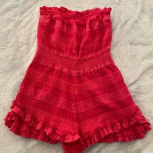 Pink strapless romper.